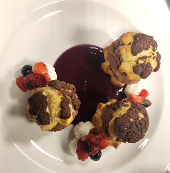Chocolate Mousse Filled Profiteroles Atop Wild Berry Coulis